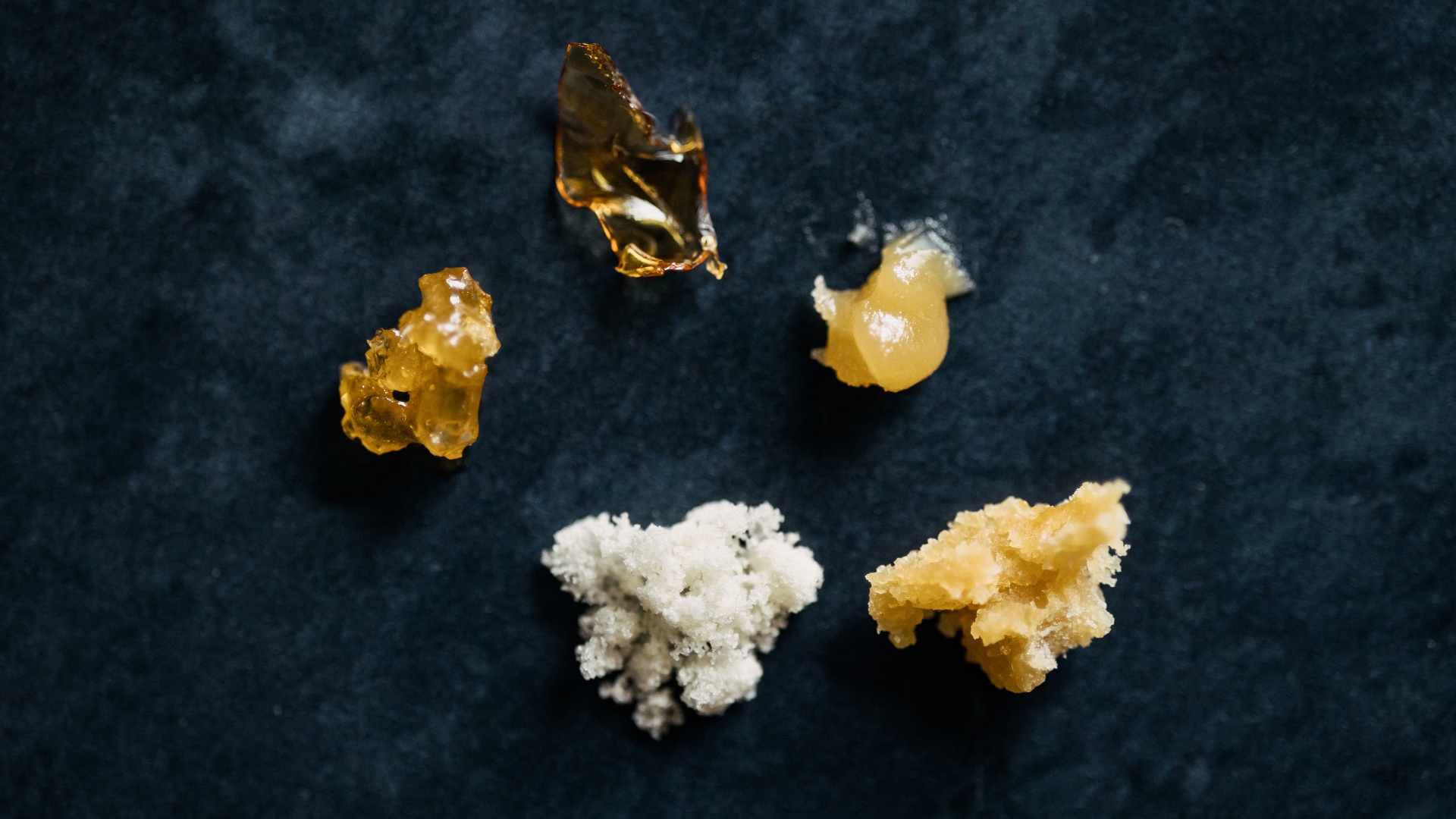 Assortment of cannabis concentrates including hash rosin and other concentrate formats.