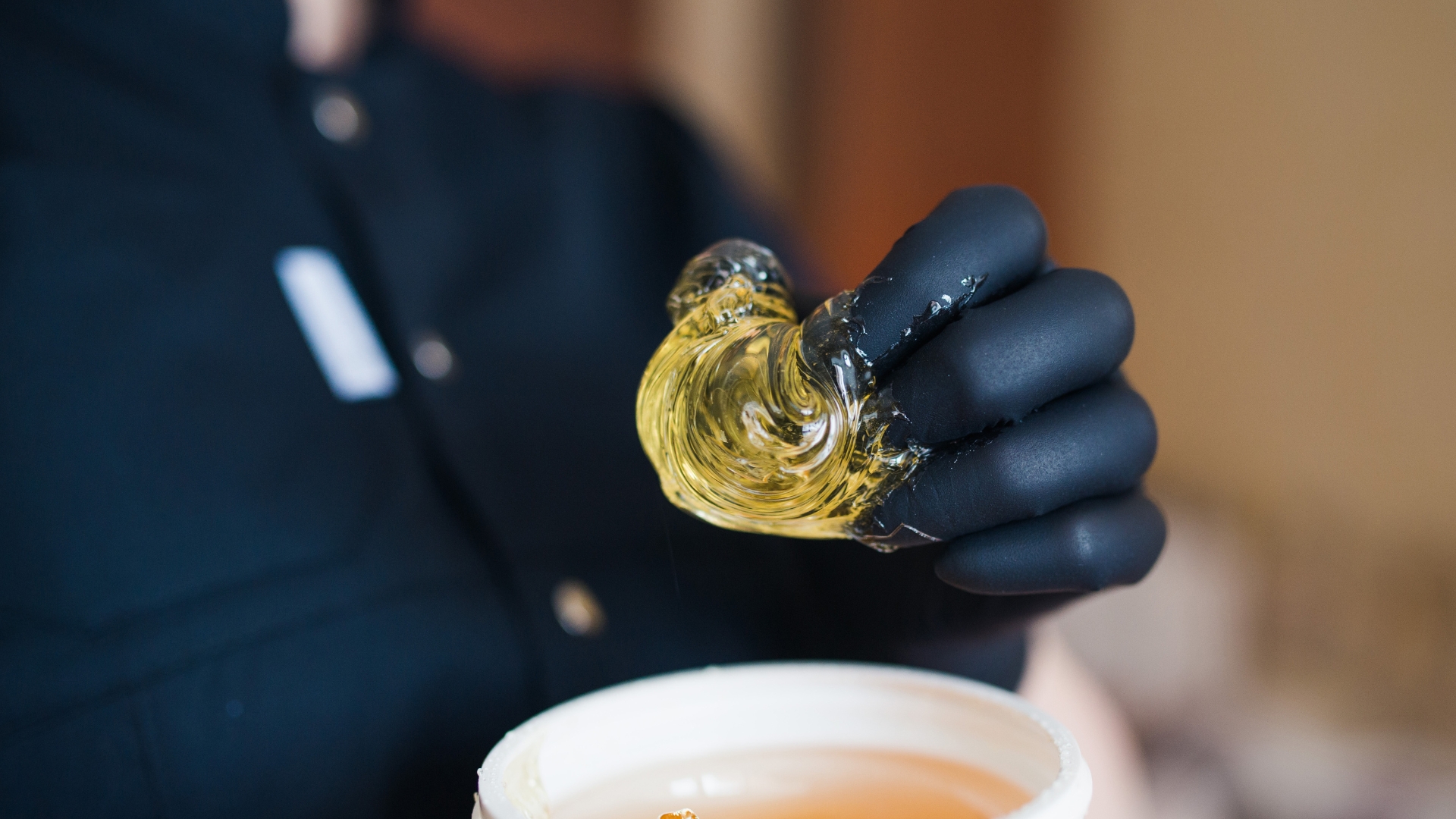 Cannabis technician producing hash rosin using a heat and pressure extraction process